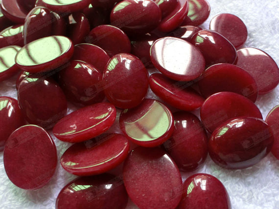 Semi precious stone dyed red jade oval cabochon